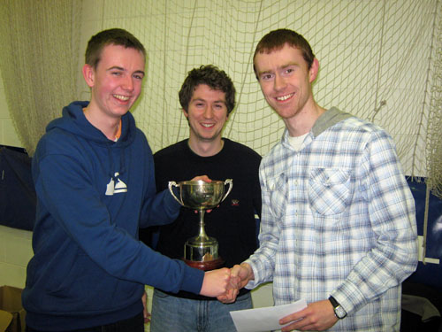 David Fitzsimons (R) receives the Philip Hogarty Memorial Trophy from Barry Mulvey (L) and Daniel Lynch of Gonzaga College