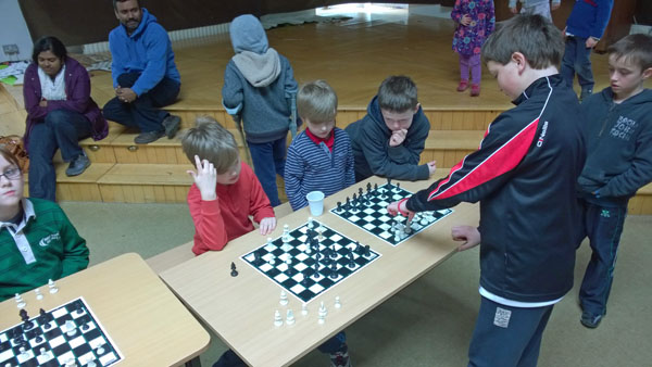 Padraig Hughes (12) giving a simultaneous display against Curragh Junior Chess Club